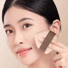 Woman holding a makeup sponge near her face -Caramel Milk Crust Mousse Powder Puff Set – [Double Headed Shape] 2pcs Boxed Pack-THE COSMETIC STORE NZ