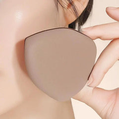 Beige silicone pad being held against a person's skin- Caramel Milk Crust Mousse Powder Puff Set – [Double Headed Shape] 2pcs Boxed Pack-THE COSMETIC STORE NZ