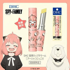 DHC Spy x Family lip cream featuring a pink tube with cartoon character graphics and a yellow cream bullet, alongside its retail box. The image includes DHC branding, a pink star badge, an anime character on the left, and a white polar bear illustration on the right, all set against a light peach background.