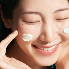 Woman applying cream to her face with a close-up focus on her skin texture.-Dr.Jart + DR.JART+ EVERY SUN DAY MOISTURISING SUN SPF50 PA++++ 30ml-THE COSMETIC STORE NZ