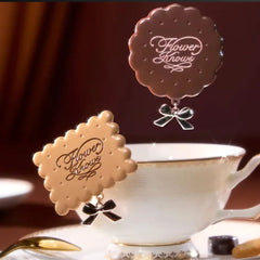 Decorative tea bag holders with 'Flower Knows' branding on a teacup.