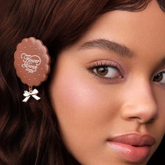 Close-up of a woman wearing a decorative hair clip with 'Flower Knows' branding.