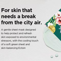 Sheet mask with text about protecting skin from city air pollution on a light gray background