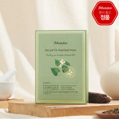 JMsolution ReLeaf Fit Heartleaf Mask packaging on a wooden surface with a blurred background