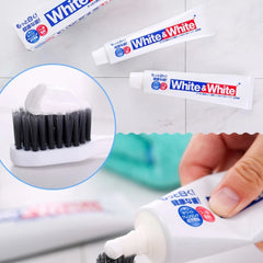White and White toothpaste tubes shown with a close-up inset of toothpaste being dispensed onto a toothbrush bristle, and a hand holding one of the tubes in a bathroom setting.-Lion White & White Toothpaste 150g [Domestic Version]-THE COSMETIC STORE NZ.