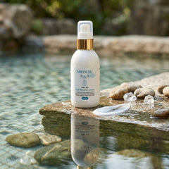 MIHAESU skincare product on a stone surface with water and rocks in the background
