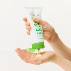 Hand holding a tube of aloe vera foam cleanser with a small amount on the palm.