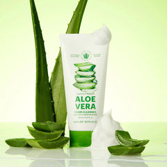 Aloe vera foam cleanser with aloe vera leaves on a light green background