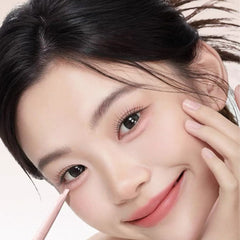 Close-up of a woman applying makeup with a brush- RH8 Dual-Tone 3D Under Eye Enhancer Pen -THE COSMETIC STORE NZ