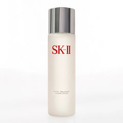 Lightweight clear watery texture of SK-II Clear Lotion poured onto a cotton pad for skin exfoliation