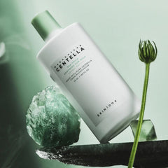 Skincare product with green plant elements on a light green background