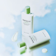Two skincare products with green and white design on a light blue background