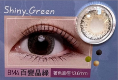 Shiny green contact lens with eye and close-up on blue background