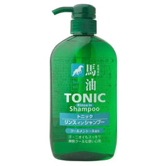 Green bottle of tonic rinse-in shampoo with pump on a white background