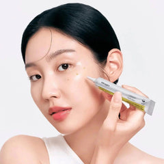 Woman applying skincare product to her face -CELIMAX The Vita-A Retinal Shot Tightening Booster 15ml- Skincare product tube with yellow gel -THE COSMETIC STORE NZ-