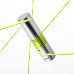 Skincare serum bottle with green label on a white background