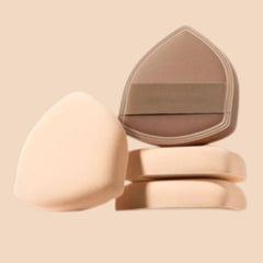 Three beige makeup sponges on a beige background