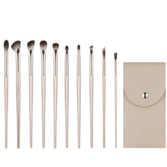 Set of makeup brushes with a beige pouch on a white background