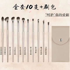 Set of makeup brushes with a carrying case on a beige background