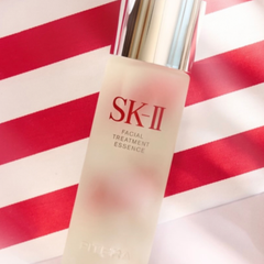 SK-II Facial Treatment Essence bottle on a red and white striped background-SK-II Facial Treatment Essence bottle and red box 75ml [Japan Domestic Versions]-available at The Cosmetic Store NZ