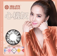 Promotional image of a contact lens package with a model and Hydron branding.