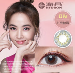 Advertisement for HYDRON contact lenses with a model, product image, and close-up of an eye wearing the lenses.
