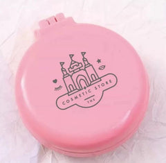 Pink cosmetic compact with castle design and 'Cosmetic Store' text on a white background