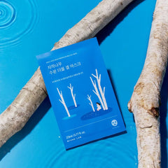 Round Lab Birch Juice Moisturizing Double Gel Mask Pack 23ml x10 ea -A facial mask packaging with birch tree design on a blue background with tree trunks.