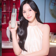 Woman holding a Sk-II product in a promotional setting-SK-II Facial Treatment Essence bottle and red box 160ml [Japan Domestic Versions]-available at The Cosmetic Store NZ