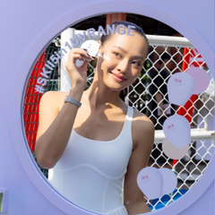 Woman applying skincare product in front of a mirror with 'SKIN'BRANCE' branding. SK-II Genoptics CC Primer bottle -tone up primer- available at The Cosmetic Store New Zealand