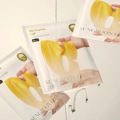 Gold face mask packages with a hand holding one, SUNGBOON EDITOR Silk Peptide EGF Intensive Gold Mask 4ea
