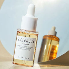 Skincare ampoule bottle with dropper on a light blue background