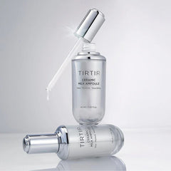 TIRTIR Ceramic Milk Ampoule bottles on a reflective surface with a light gray background