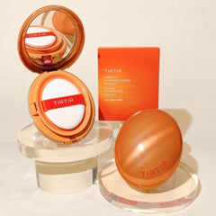 TIRTIR makeup product set with compact, sphere, and packaging on a light background