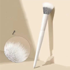 White makeup brush and round disc on a beige background