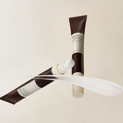 Two tubes of Kiehl's cream on a beige background