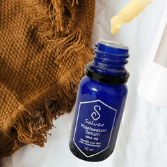 Blue serum bottle with 'S' logo on a white background