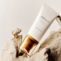 Skincare product with a bottle on a textured beige background
