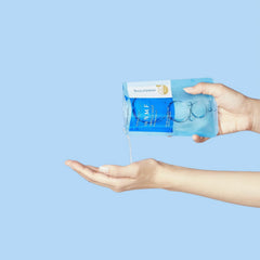 Hand holding a blue package with a clear liquid being poured onto another hand -Nature Republic Aloe Vera Gel and MEDIHEAL N.M.F Ampoule Mask promotional gift set-THE COSMETIC STORE NZ