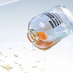 Bottle of Franky PDRN Serum with droplets on a light background