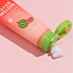 TONYMOLY Watermelon Soothing Gel Cream tube with a green cap, shown with white gel cream squeezed out on a pink background.