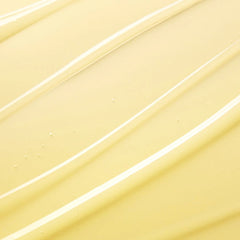 A close-up texture shot of a smooth, creamy pale yellow cosmetic cream with diagonal swirled strokes and tiny droplets.-Milky, fluid texture swatch of Torriden SOLID IN 5D Ceramide daily moisturizing essence
