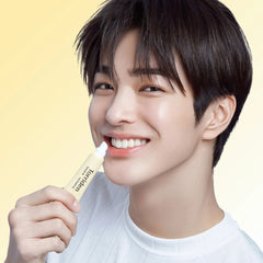 Person holding a skincare product -Glossy translucent gel texture swatch of Torriden SOLID IN moisturizing ceramide lip treatment