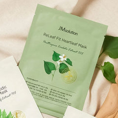 Green sheet mask packaging with JMsolution branding and leaf design on a beige background