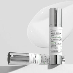 Two skincare bottles with labels on a white background