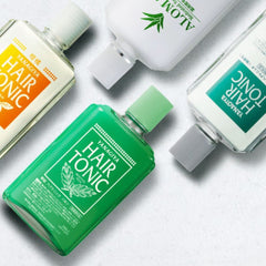 Four YAMAGOTA Hair Tonic bottles arranged diagonally on a light gray textured background. The bottles include clear liquid in white, green, and orange-tinted containers with white caps and green YAMAGOTA branding.- Yanagiya Haie Tonic -Unscented Cool 240ml-THE COSMETIC STORE NZ