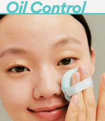 Person using a facial cleansing pad with 'Oil Control' text above.