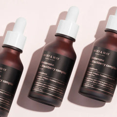 MARY&MAY Idebenone Blackberry Complex Serum (80ml) Seoul Edition-Three bottles of Mary & May skincare serum on a light pink background