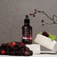 MARY&MAY Idebenone Blackberry Complex Serum (80ml) Seoul Edition-Bottle of Mary & May product with berries and a branch on a gray background