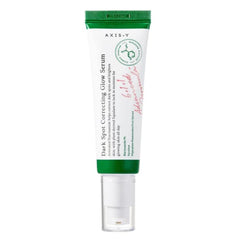 A tube of AXIS-Y DARK SPOT CORRECTING GLOW SERUM with a green cap and white label.